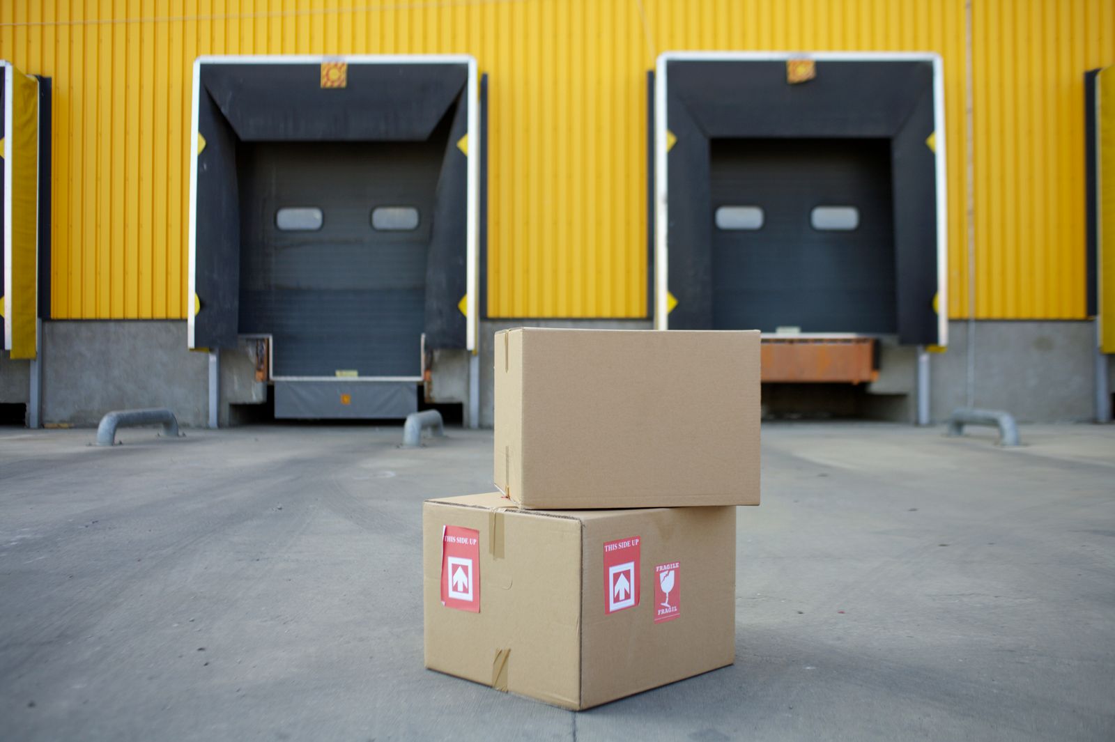 Cardboard boxes stacked at warehouse loading doors