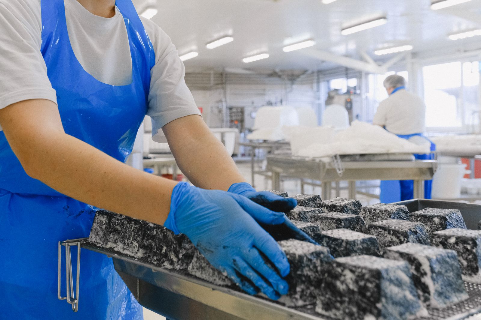 Workers in sterile gear handling product in a food plant