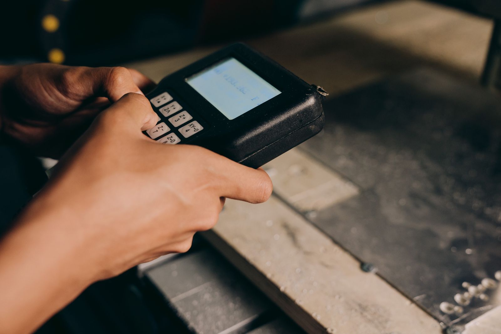 Hands operate an electronic control panel