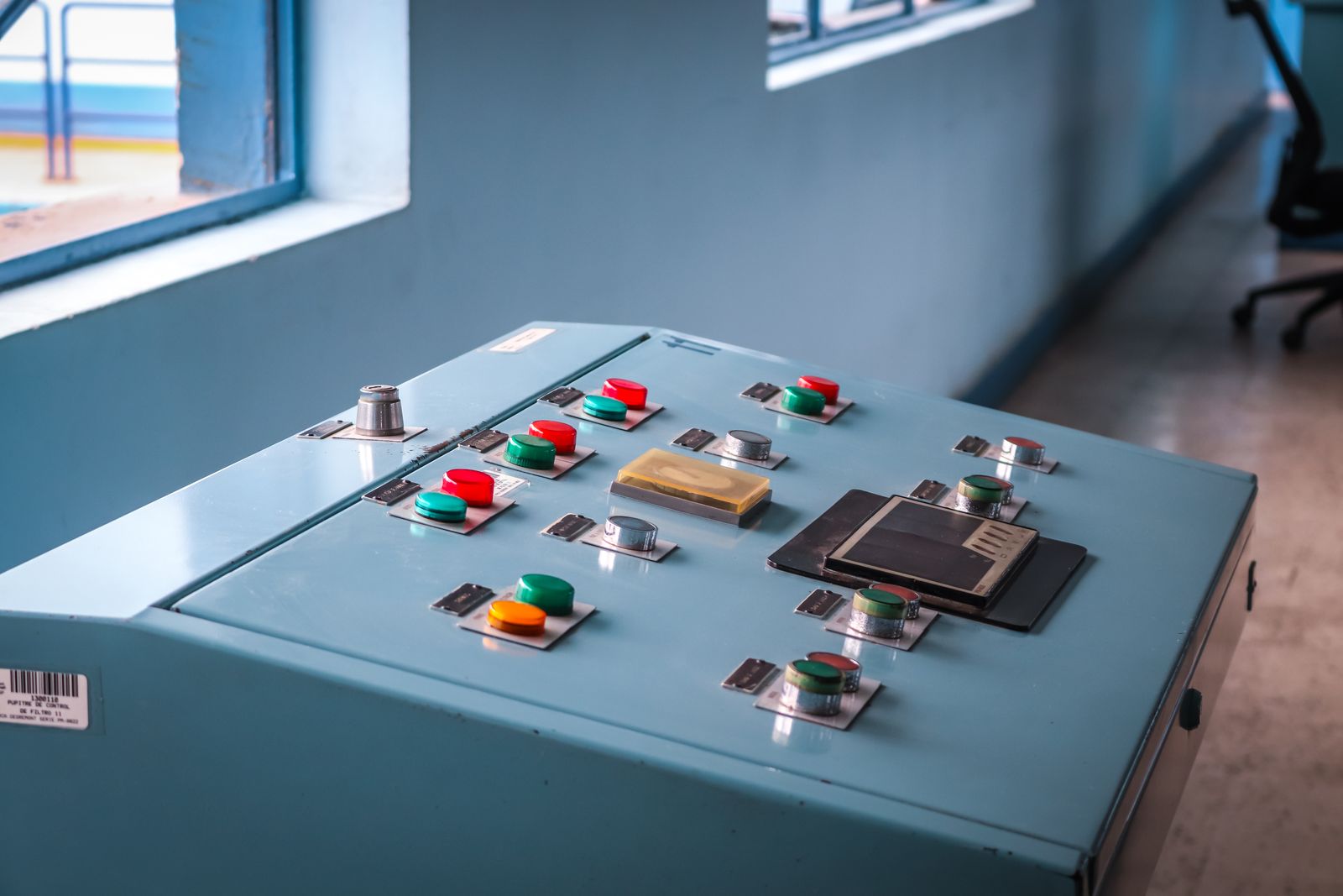 An industrial control panel with colored buttons