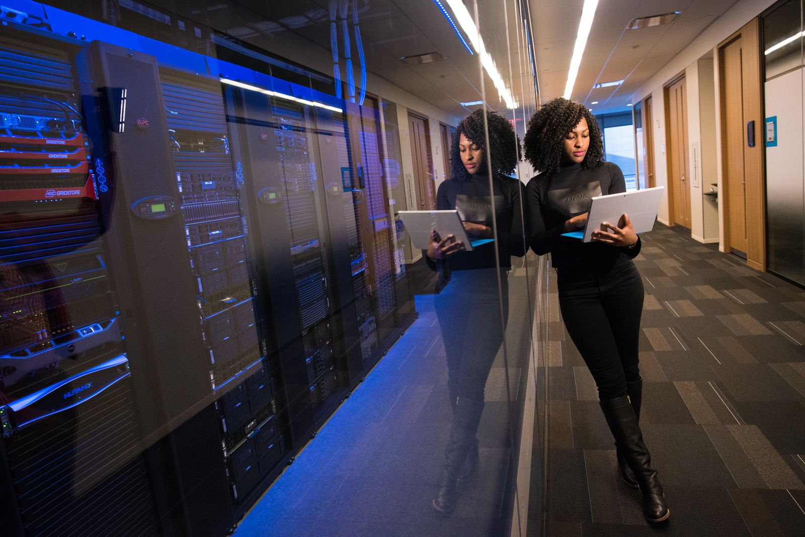 A technician with a laptop in a data center