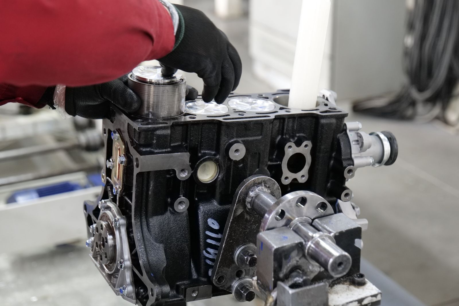 A mechanic works on engine assembly