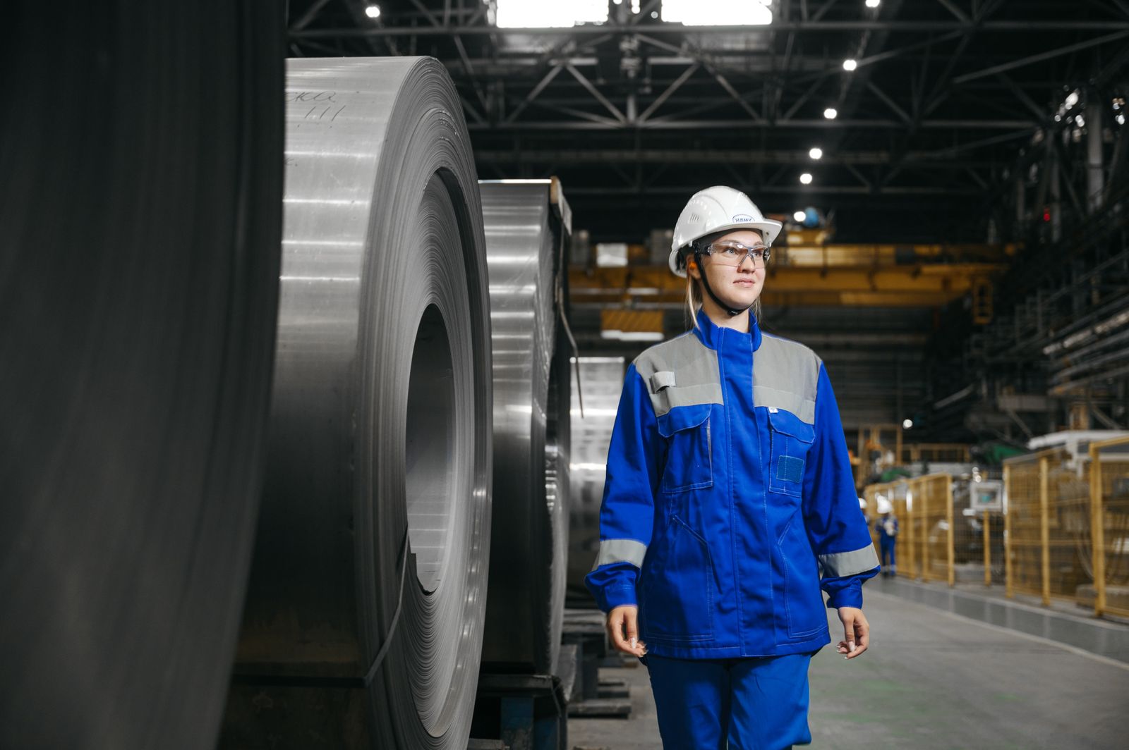 An industrial worker in protective gear at a plant