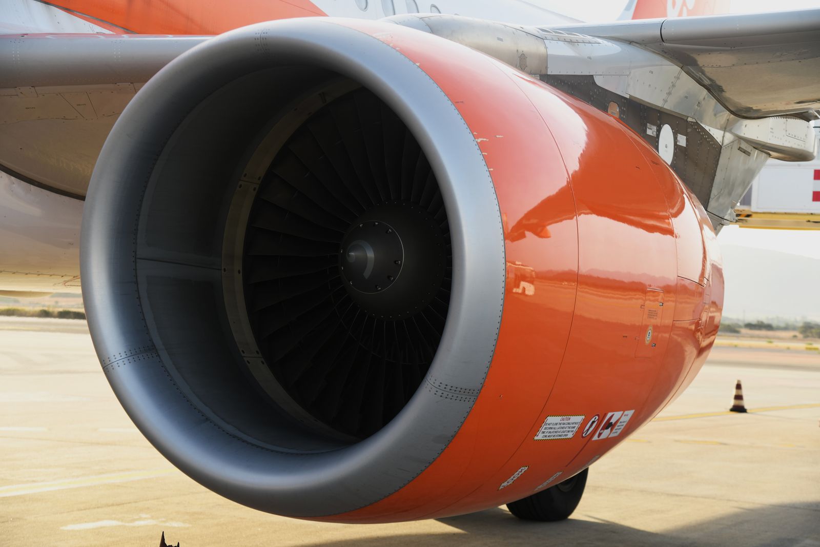 The orange engine of a commercial airplane