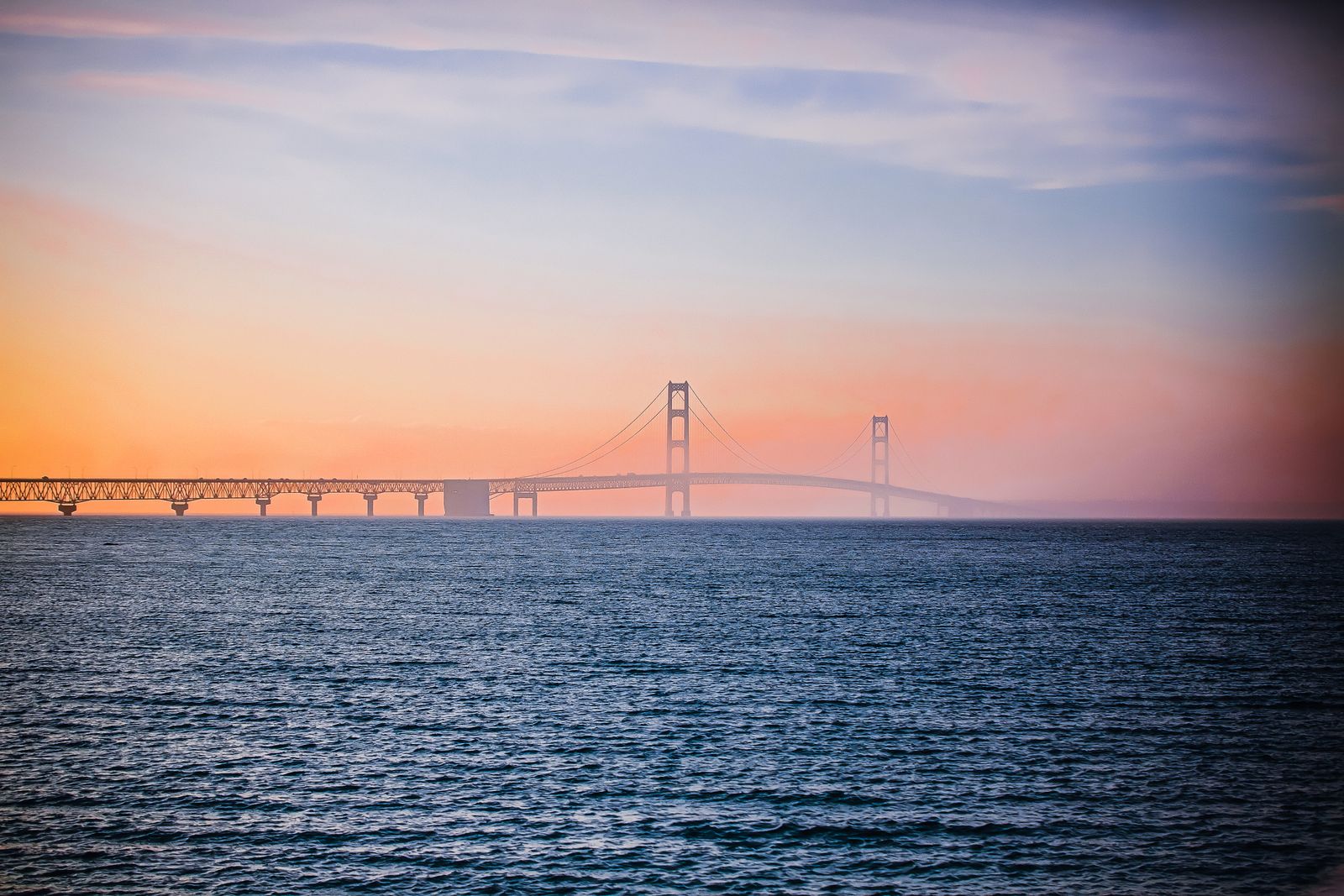 The Mackinac Bridge at sunset over the Straits of Mackinac