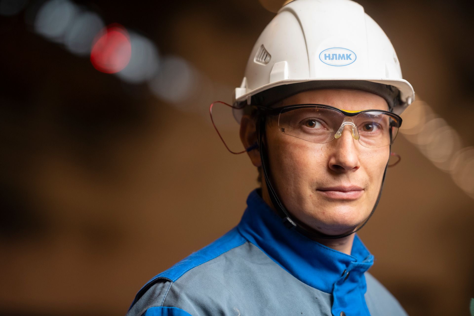 An engineer in a hard hat on a plant floor