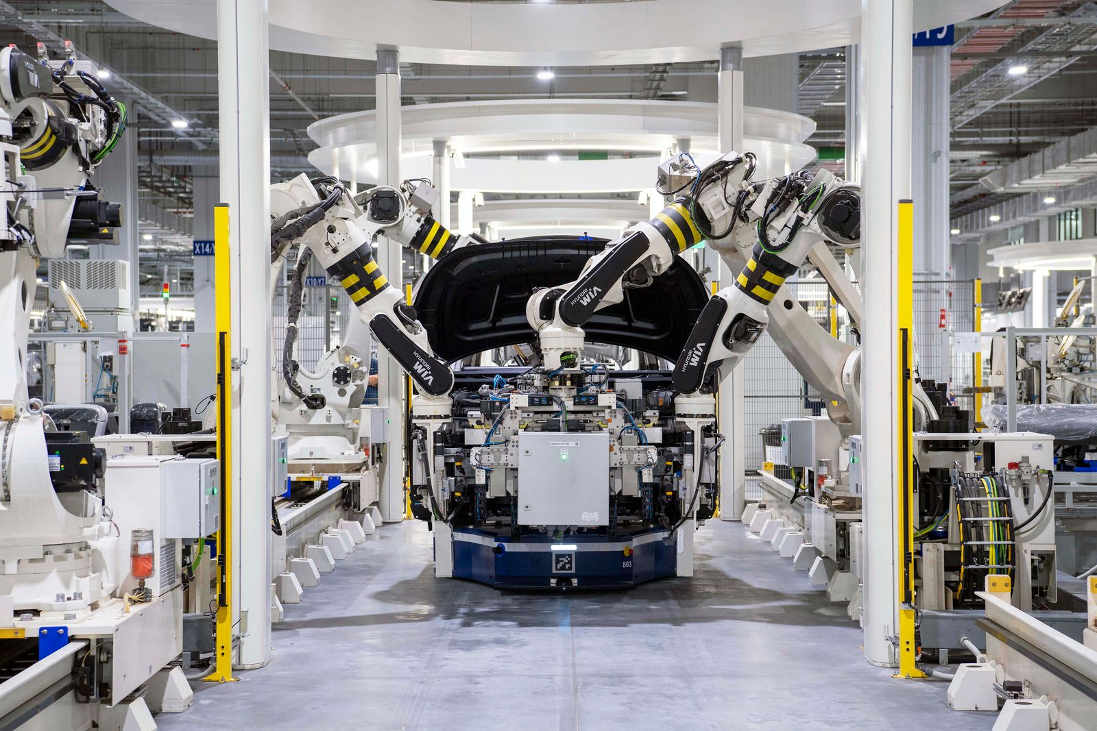 Robots assembling a car in a modern factory