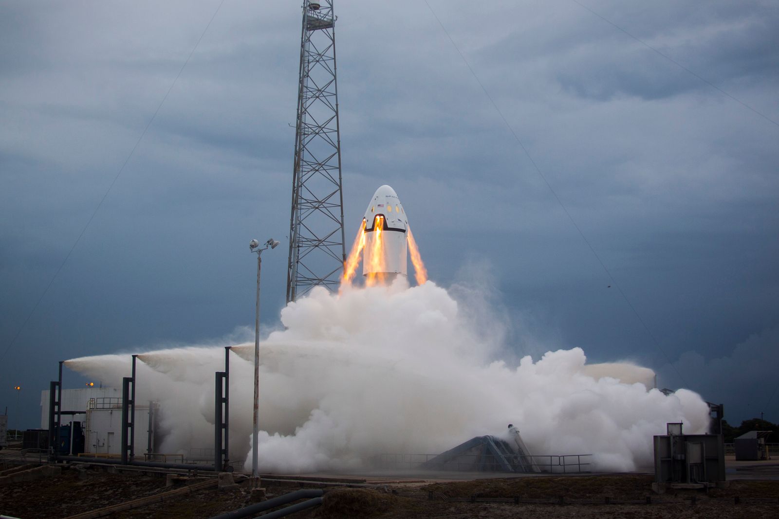 A rocket lifting off from its launch pad on a plume of flame and smoke