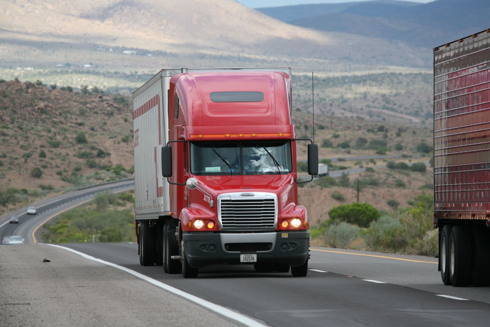 A semi truck on a scenic highway