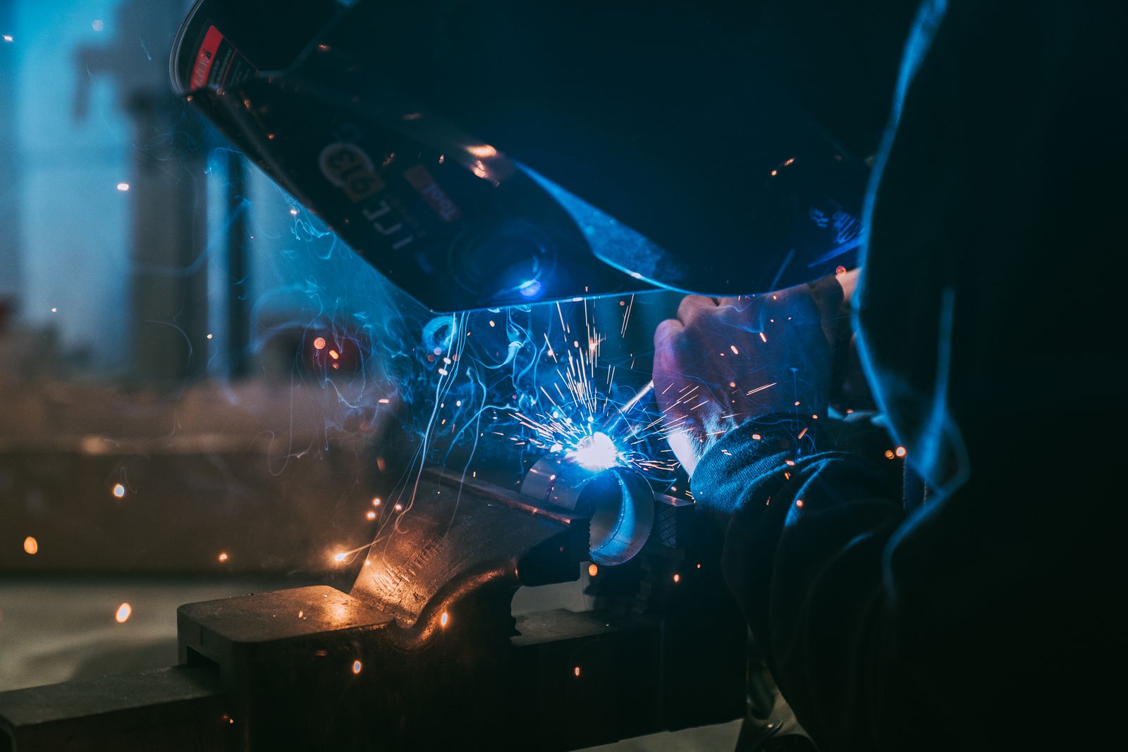 Close up of a welder with sparks flying