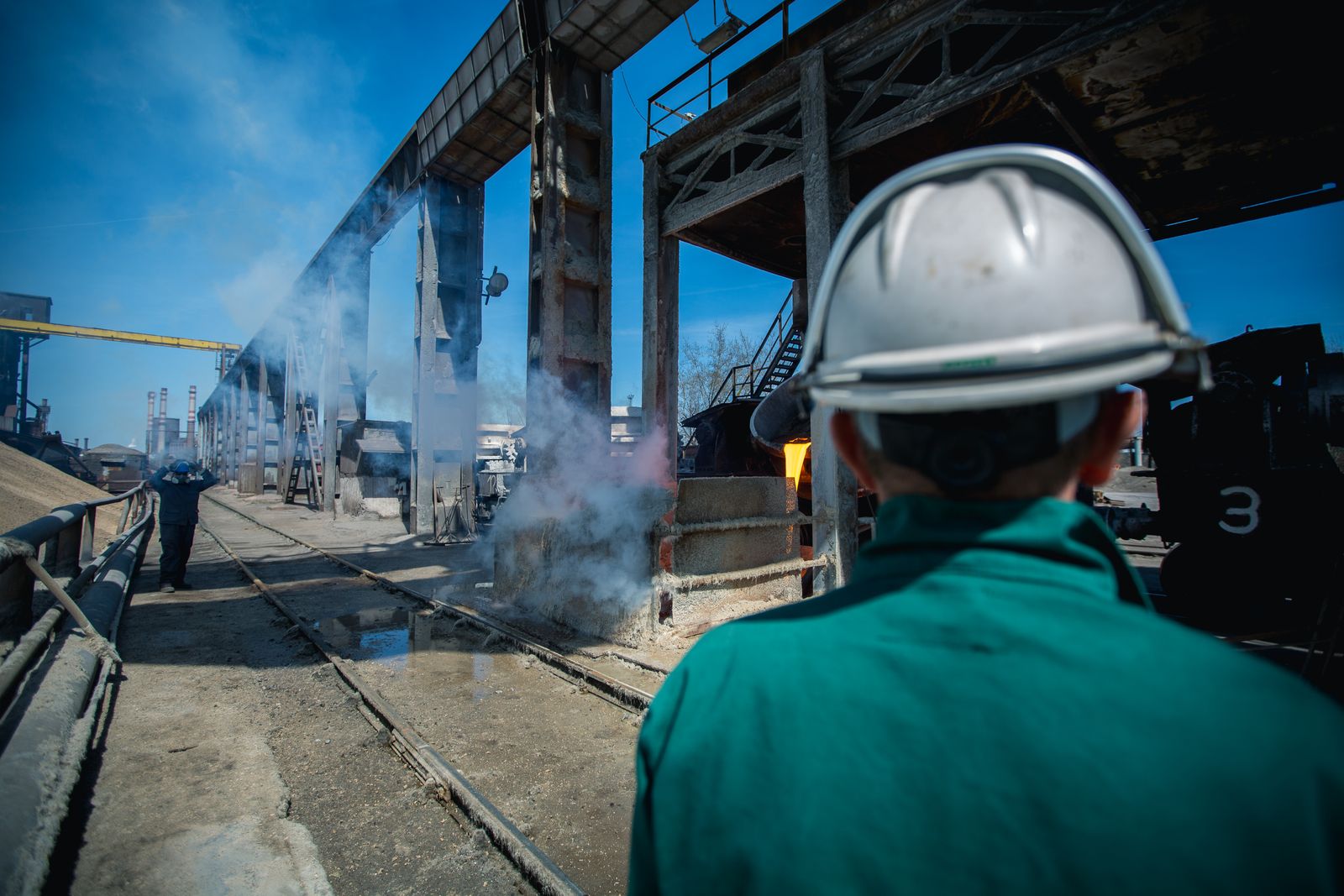 A worker in a hard hat observes the work site